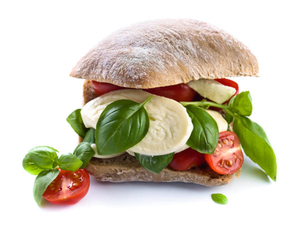 istock Ciabatta with mozzarella, tomatoes and basil isolated on white 991081270