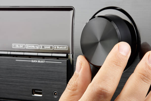 istock Closeup male hand turning blank knob amplifier 991083972