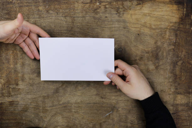 istock male hands holding a white blank sheet of paper 991089652