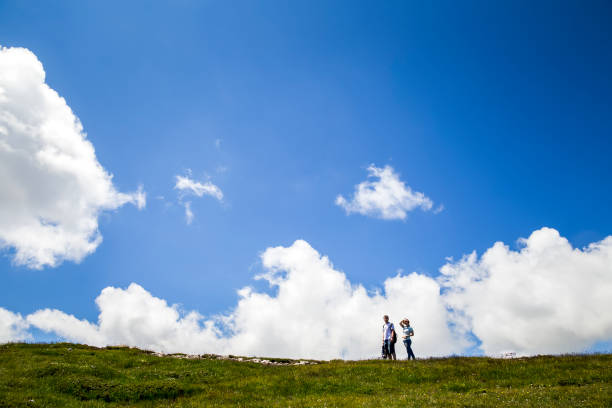 istock Couple walking across a meadow on a plateau 991095960