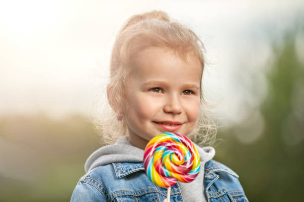 istock Smiling little girl with lollipop 991099756