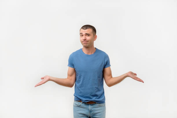 istock Closeup portrait young man shrugging shoulders. I don't know concept 991107124