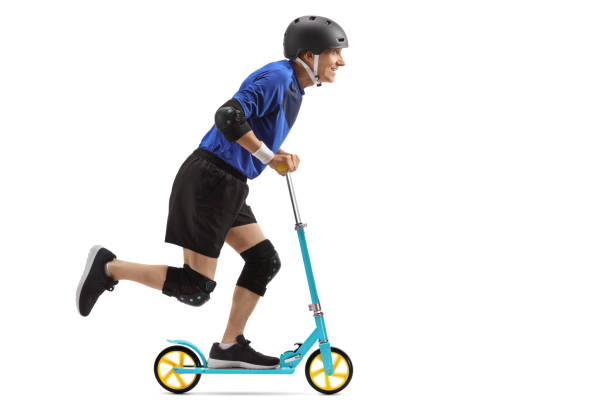 istock Senior wearing protective equipment riding a scooter 991108856