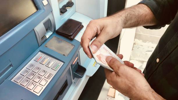 istock Turkish Man Hands Giving Money to ATM 991115112