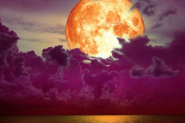 istock super full blood moon back magenta cloud over the sea 991130488