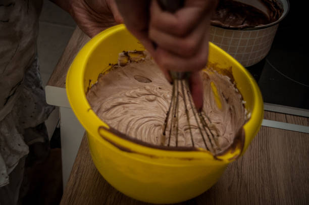 istock Making pudding, Woman hand smearing chocolate cream 991130548