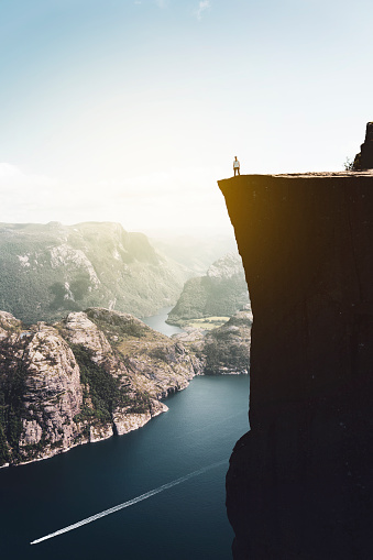 The alone woman standing on the preikestolen rock at Norway.