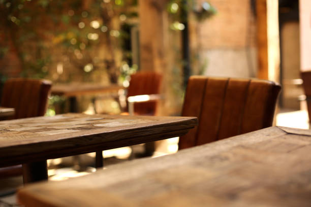 istock Wooden table and blurred background of cafe 991136510