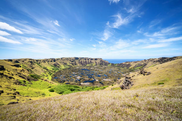 Beautiful Rano Kau Volcano Crater Lake under blue summer sky. Rano Kau is a extinct volcano that forms the southwestern headland of Easter Island, Isla de Pascua, Polynesia, Chile.