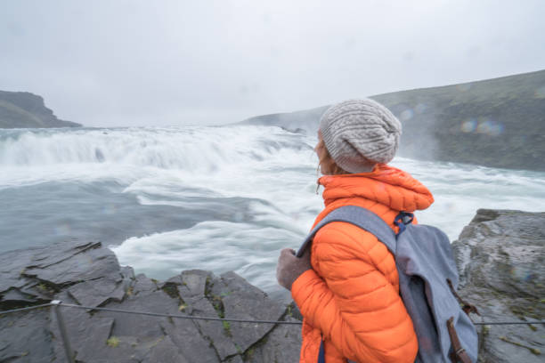 istock Young woman contemplating Gulfoss waterfalls 991142778