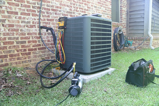 Air Conditioner Maintenance with gauges and vacuum pump