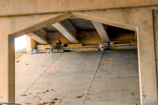 Homeless person who has set up table and chair beneath overpass in the winter Tulsa Oklahoma USA2 28 2018