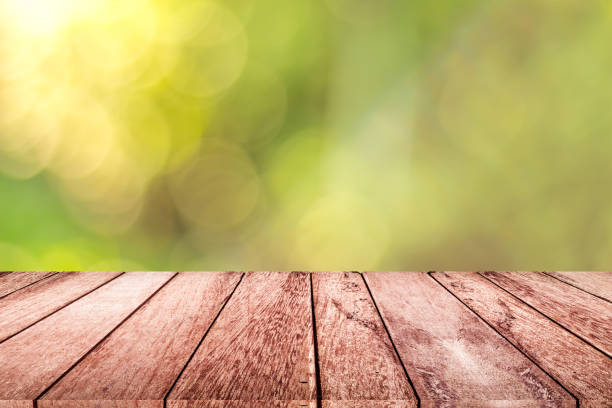 istock empty wooden on blurred nature backdrop. Wood table top. can used for display or montage your products 991159536