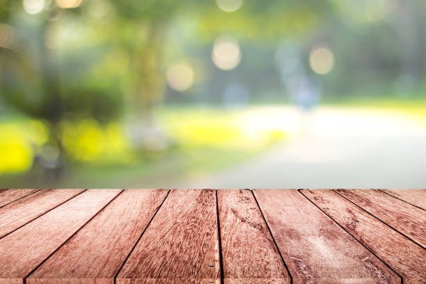istock empty wooden on blurred nature backdrop. Wood table top. can used for display or montage your products 991160210