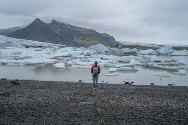 istock Young man contemplating glacier lake in Iceland 991161268