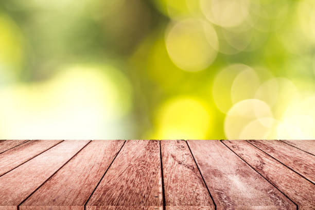istock empty wooden on blurred nature backdrop. Wood table top. can used for display or montage your products 991165258
