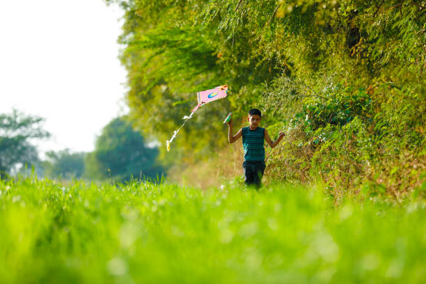 istock indian child playing with kite 991166916