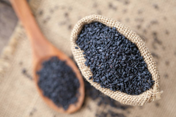 istock black sesame seeds on sack cloth and wooden background 991168244