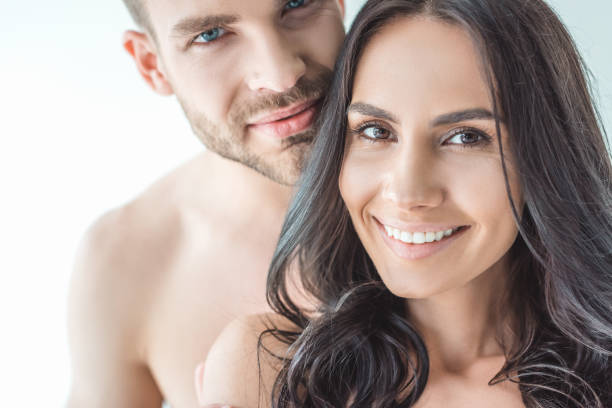 istock beautiful young couple looking at camera, isolated on white 991172762