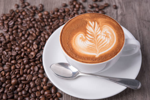 istock latte or Cappuccino with frothy foam, coffee cup top view on table in cafe. 991173012