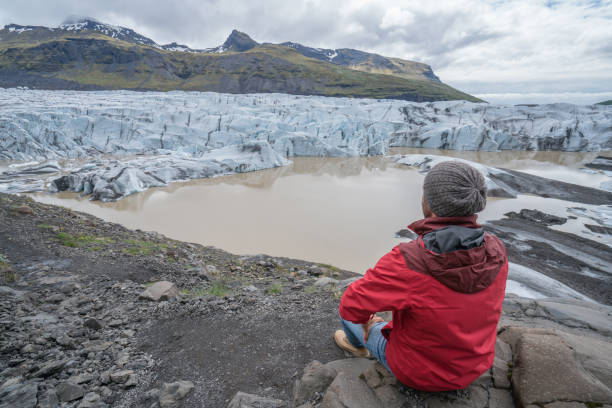 istock Young man contemplating glacier lake in Iceland 991175656