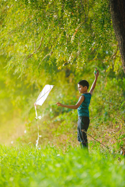 istock indian child playing with kite 991175944