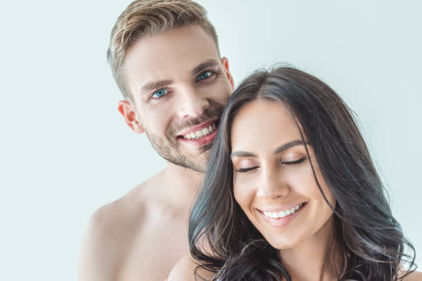 istock happy young couple standing together, isolated on white 991175968