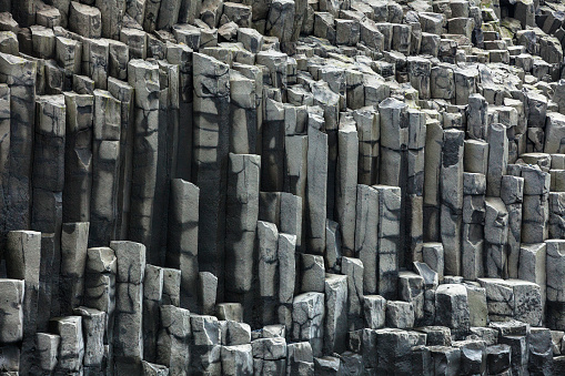 Columnar jointing basalt cliffs at Reynisdrangar beach in Iceland.