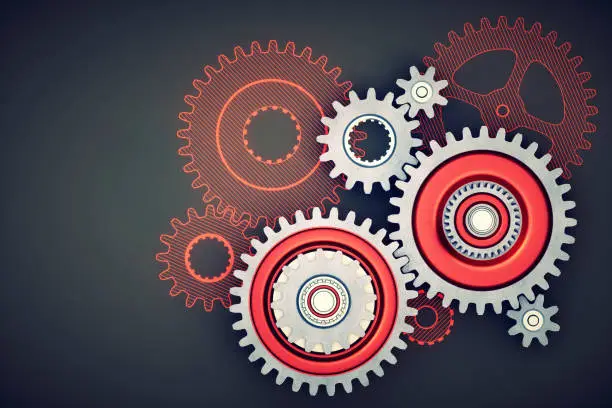 Photo of Abstract gearbox machinery setup with red gears on dark surface