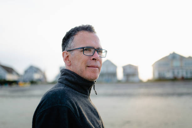 istock Man walking on the beach, Maine beach, USA 991189992