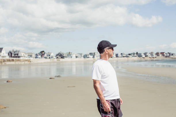 istock Man walking on the beach, Maine beach, USA 991190190
