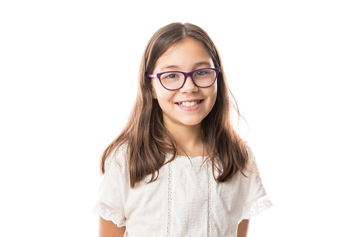Portrait of a cute smiling ten years girl in spectacles