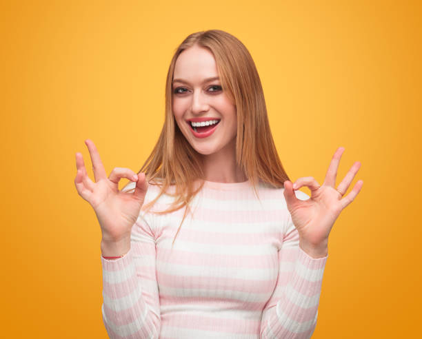 istock Cheerful woman gesturing Ok 991199968