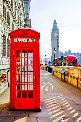 Red phone booth from London isolated on white background.