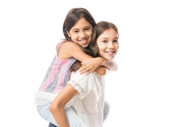 istock Cute young sister hugging older sister on white background 991200980
