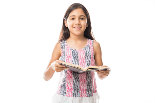 istock Little girl reading book isolated on white 991203430