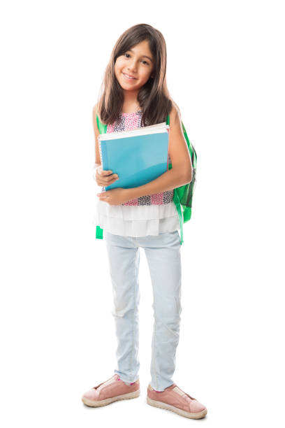 Full-length of smiling cute student with books and bags standing isolated over white background