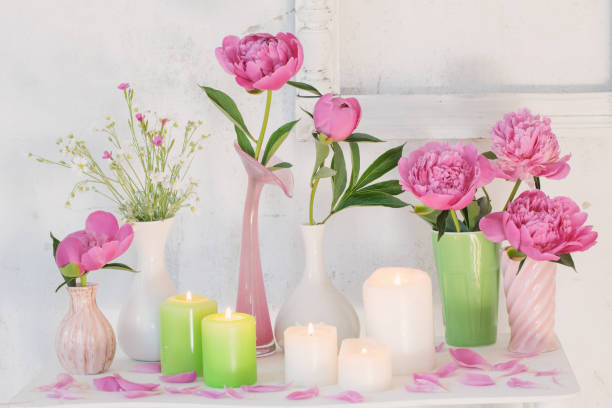 istock flowers in vases and candles on white background 991204024