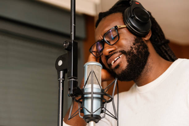 istock African young man singing on musical studio. 991204560
