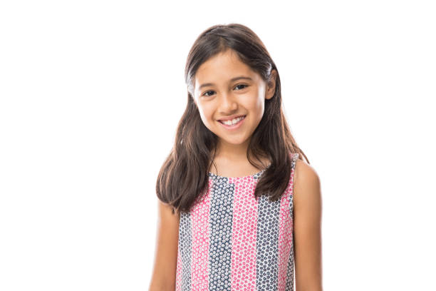 Smiling young hispanic girl posing and looking at the camera over white background Portrait of young beautiful little girl with t-shirt smiling to camera over white background 8 9 years stock pictures, royalty-free photos & images