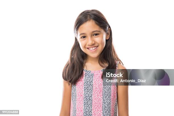 Smiling Young Hispanic Girl Posing And Looking At The Camera Over White Background Stock Photo - Download Image Now
