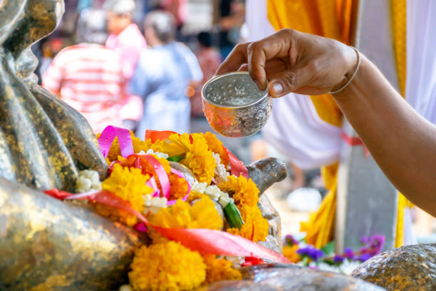 istock A Buddhist extending an arm to pour water over a Buddha statue, a traditional cleaning given during the Thai new year 991211284