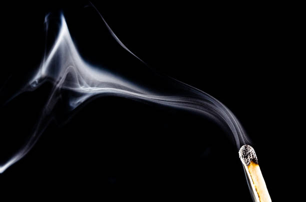 istock Smoke Swirling from Burnt Wooden Matchstick 991214358