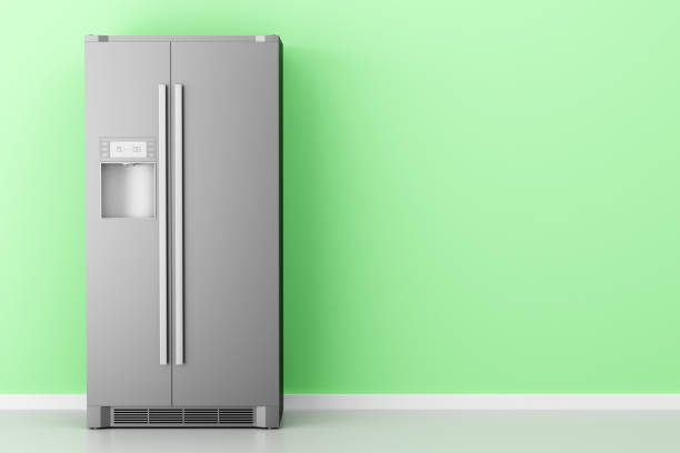 istock modern fridge in front of green wall 991216142