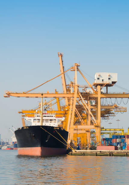 istock Container Cargo freight ship with working crane bridge in shipyard in singapore 991218666