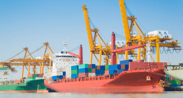 istock Container Cargo freight ship with working crane bridge in shipyard in singapore 991218870