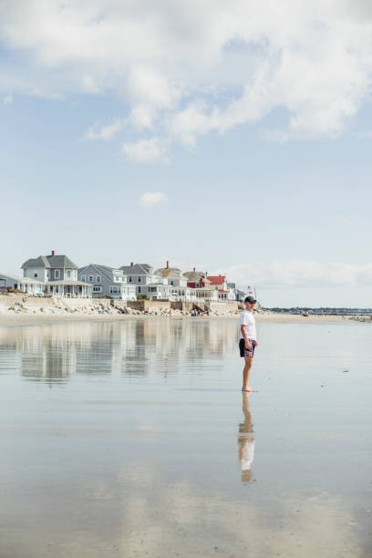 istock Man walking on the beach, Maine beach, USA 991219544