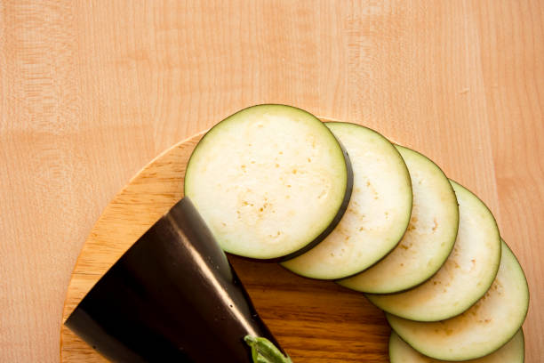 istock sliced eggplant circles on the cutting Board and chef's knife 991220928
