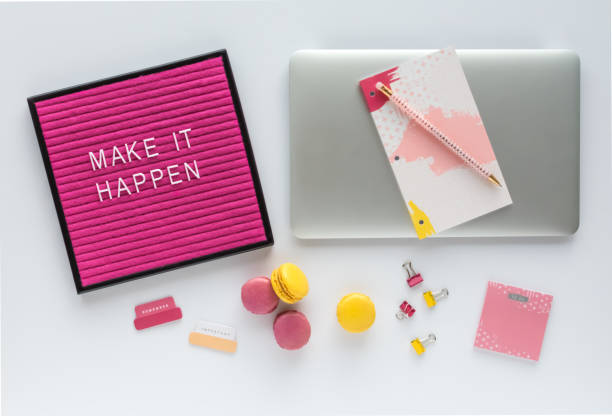 istock Colorful Work Space with Laptop Computer, Inspirational Letter Board Quote, Agenda, Office Accessories and French Macarons 991222628