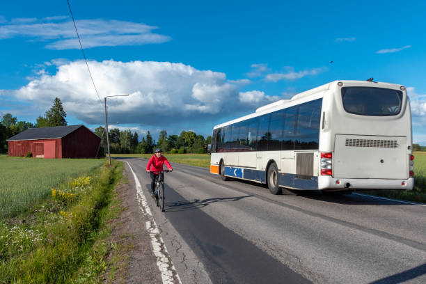 istock Woman bicycling on road 991235012
